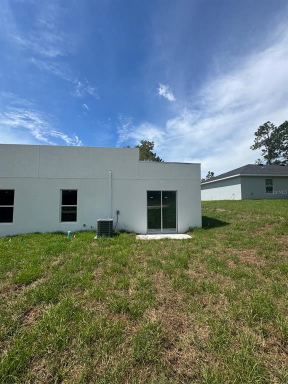 9187 North Travis Drive, Unit 9189 Citrus Springs, FL 34434 - Photo 2 of 21 a house view with a garden space