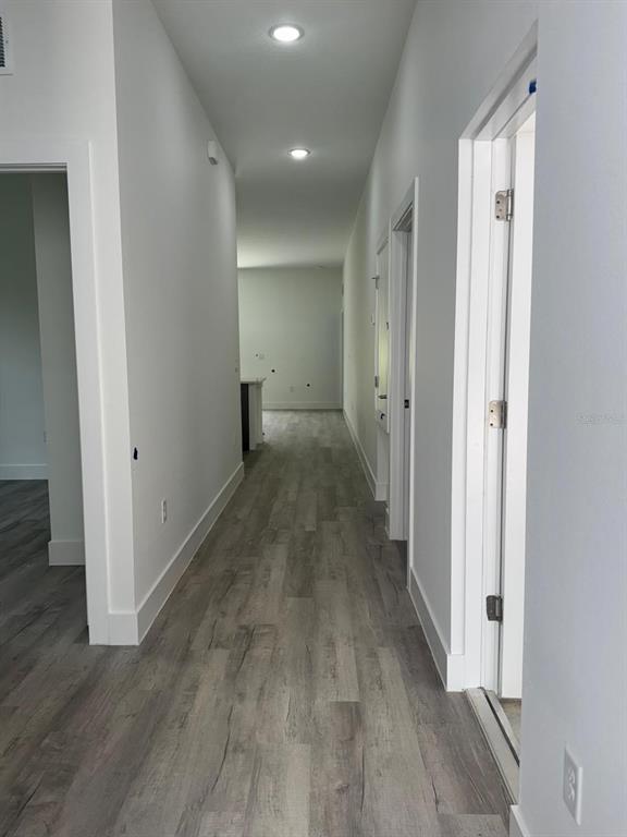 9187 North Travis Drive, Unit 9189 Citrus Springs, FL 34434 - Photo 6 of 21 a view of a hallway with wooden floor