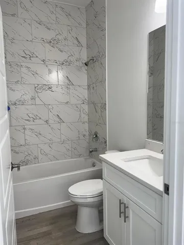 an empty room with wooden floor and a window