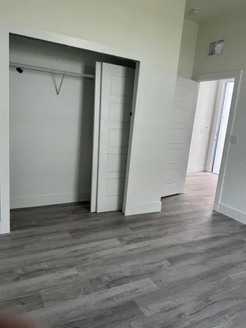 a view of a room with wooden floor