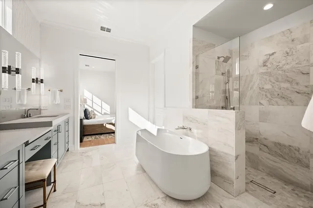 a bathroom with a tub sink and mirror