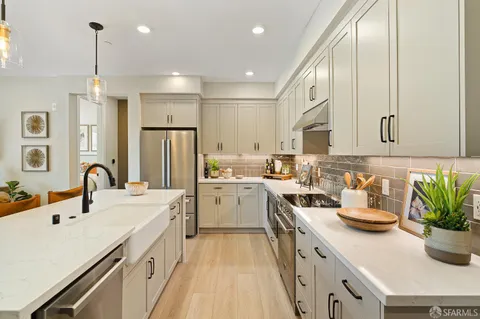 a kitchen with a sink a stove and cabinets