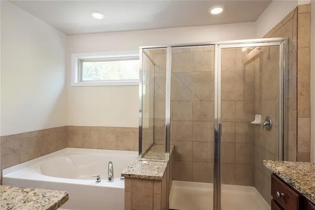 a bathroom with a bathtub and a shower