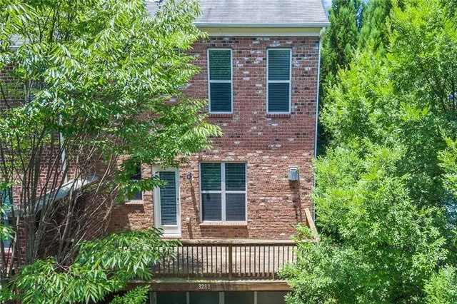 front view of a house with a tree