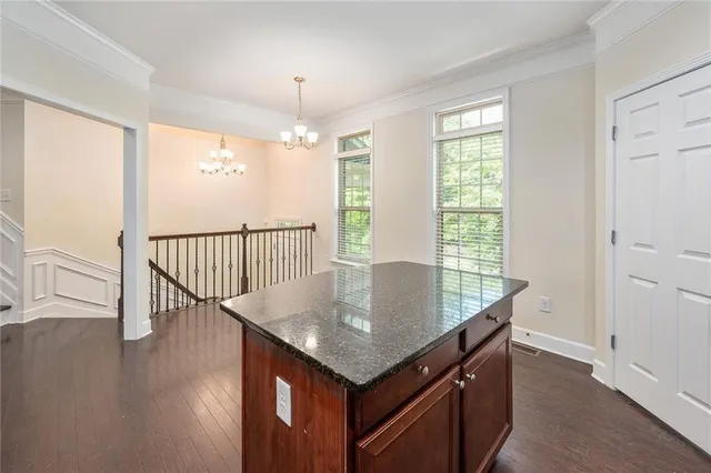 an open kitchen with wooden floor and window