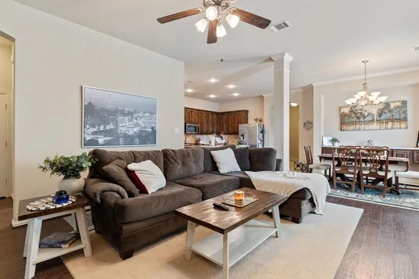 a living room with furniture and a chandelier