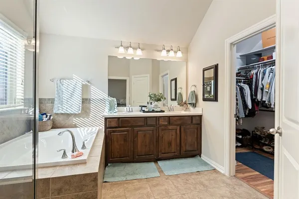 a bathroom with a sink a mirror and shower