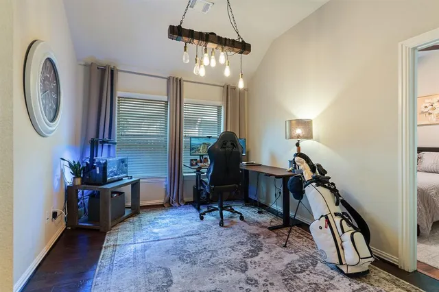 a view of a workspace with furniture and a window