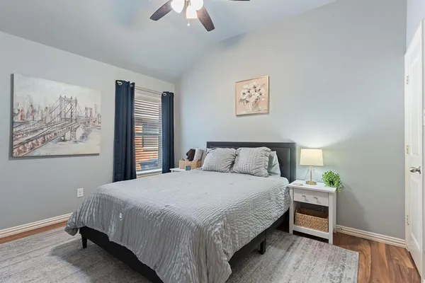 a bedroom with a bed and a painting on the wall
