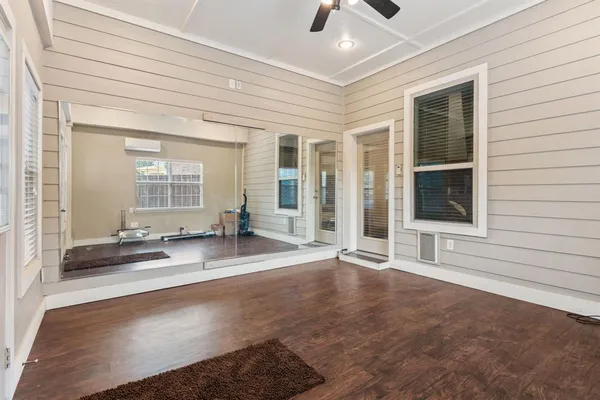 a view of a livingroom with wooden floor and kitchen space