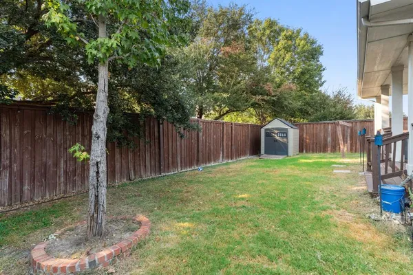 a backyard of a house with table and chairs