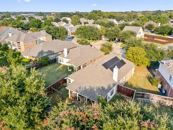 an aerial view of a house with a yard