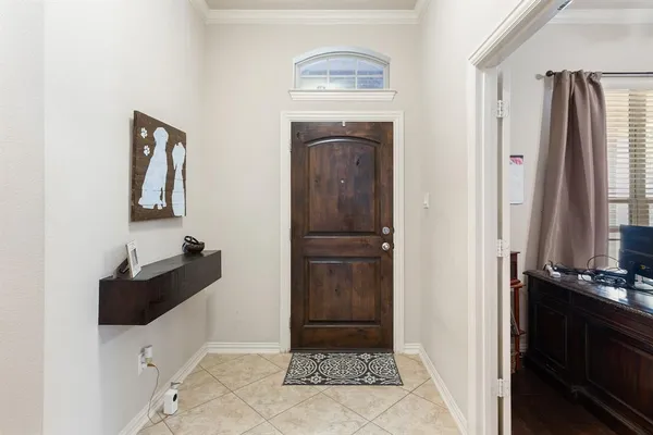 a hallway with front door and mirror