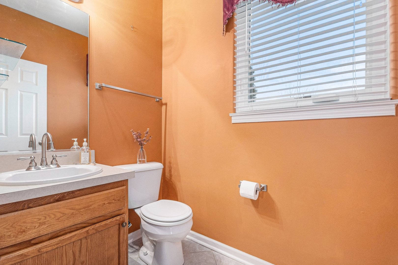 1616 Stanton Lane Plainfield, IL 60586 - Photo 12 of 40 a bathroom with a toilet sink vanity and mirror