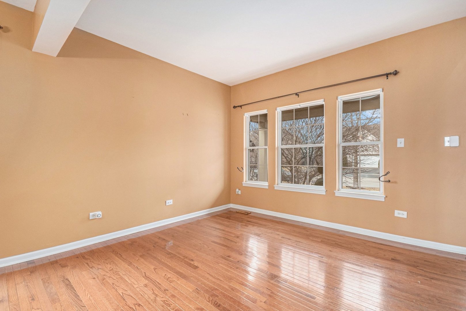 1616 Stanton Lane Plainfield, IL 60586 - Photo 4 of 40 a view of an empty room with wooden floor and a window