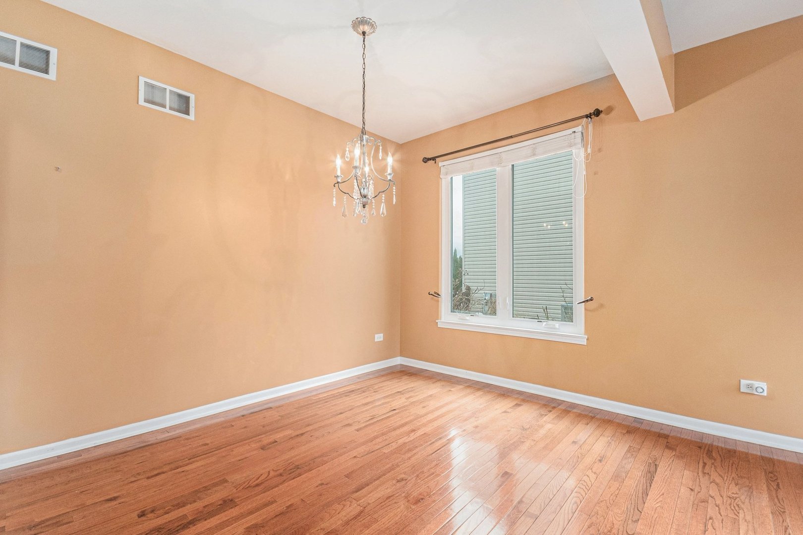 1616 Stanton Lane Plainfield, IL 60586 - Photo 6 of 40 a view of an empty room with wooden floor and a window