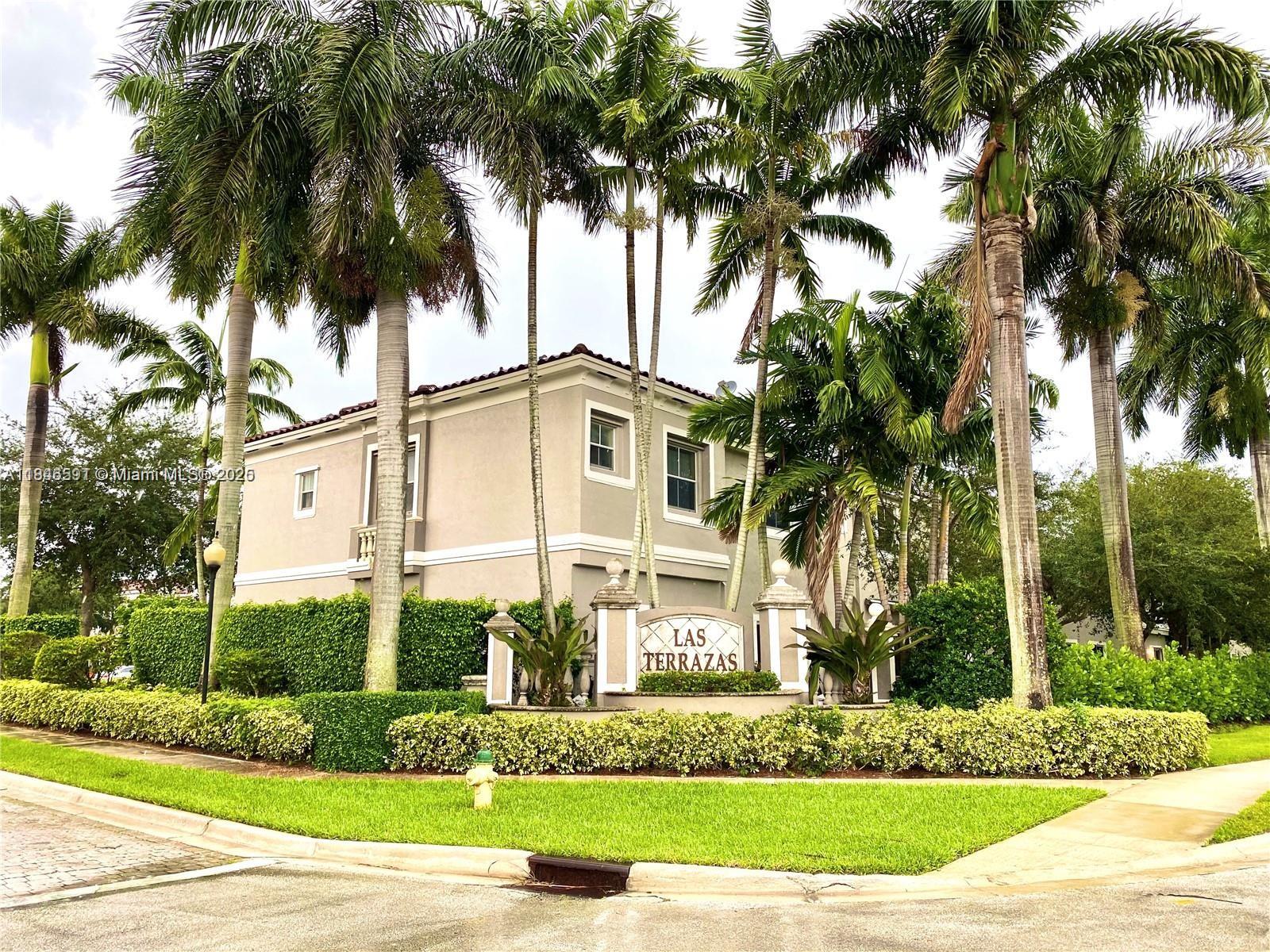 4908 Southwest 141st Avenue, Unit 3 Miramar, FL 33027 - Photo 1 of 29 a front view of a house with a garden