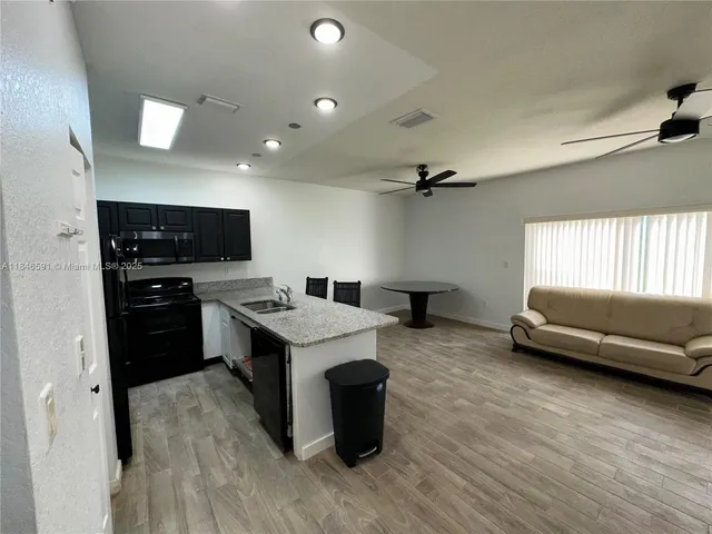 a kitchen with a table and chairs in it