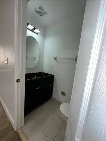 a view of a hallway with wooden floor and stairs