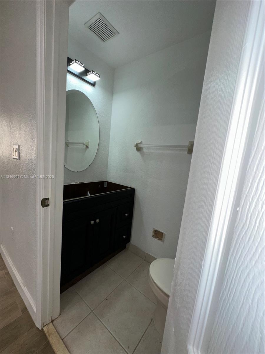 4908 Southwest 141st Avenue, Unit 3 Miramar, FL 33027 - Photo 15 of 29 a bathroom with a double vanity sink and mirror