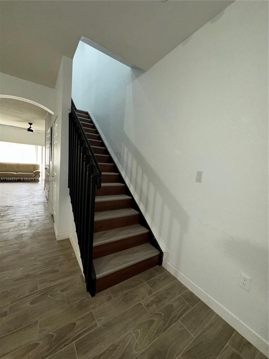 4908 Southwest 141st Avenue, Unit 3 Miramar, FL 33027 - Photo 16 of 29 a view of a hallway with wooden floor and stairs