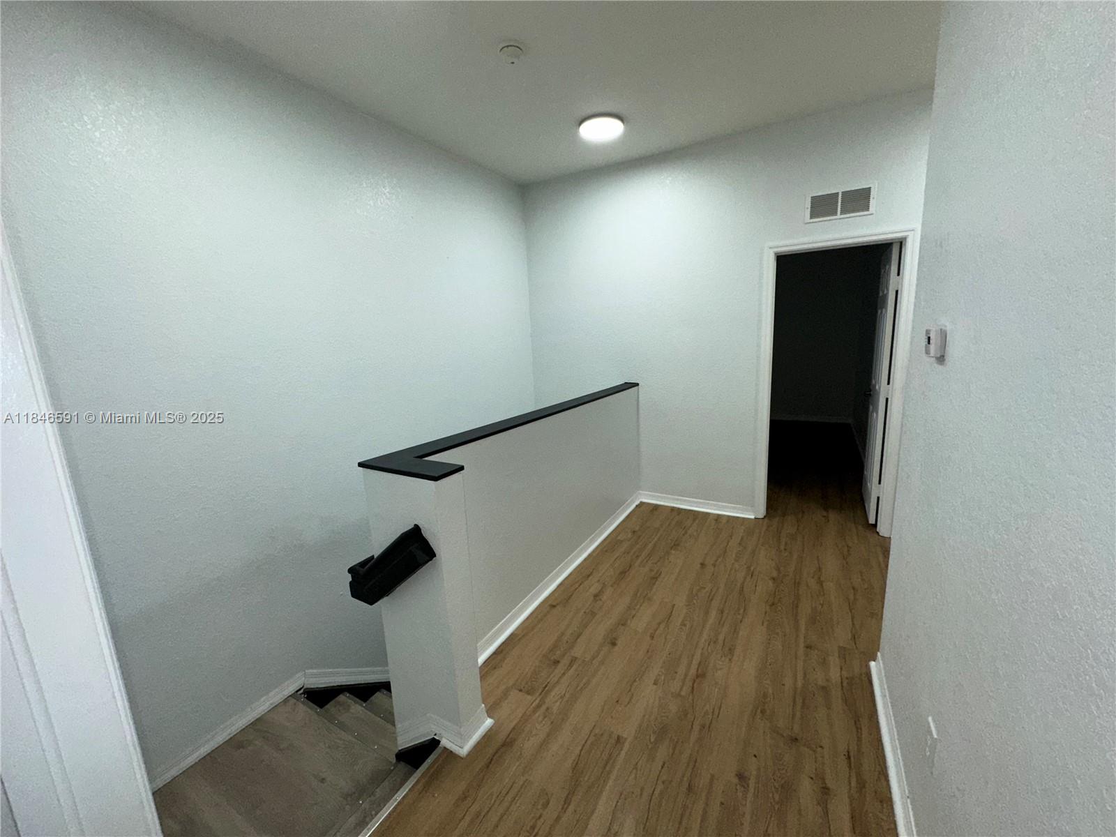 4908 Southwest 141st Avenue, Unit 3 Miramar, FL 33027 - Photo 22 of 29 wooden floor in an empty room