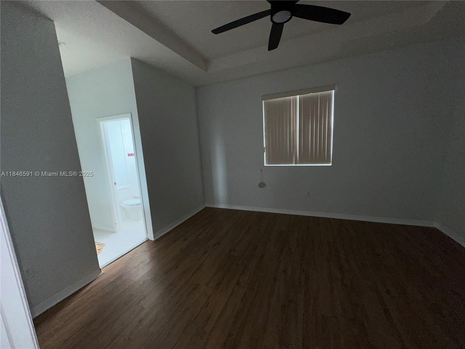 4908 Southwest 141st Avenue, Unit 3 Miramar, FL 33027 - Photo 23 of 29 a view of an empty room with wooden floor