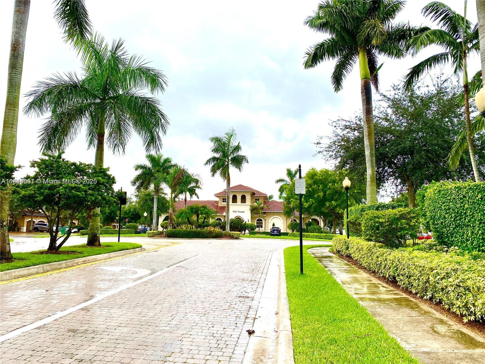 4908 Southwest 141st Avenue, Unit 3 Miramar, FL 33027 - Photo 25 of 29 a view of a yard and palm trees