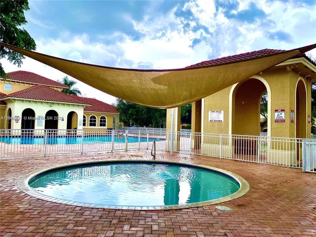 a view of swimming pool with a bench