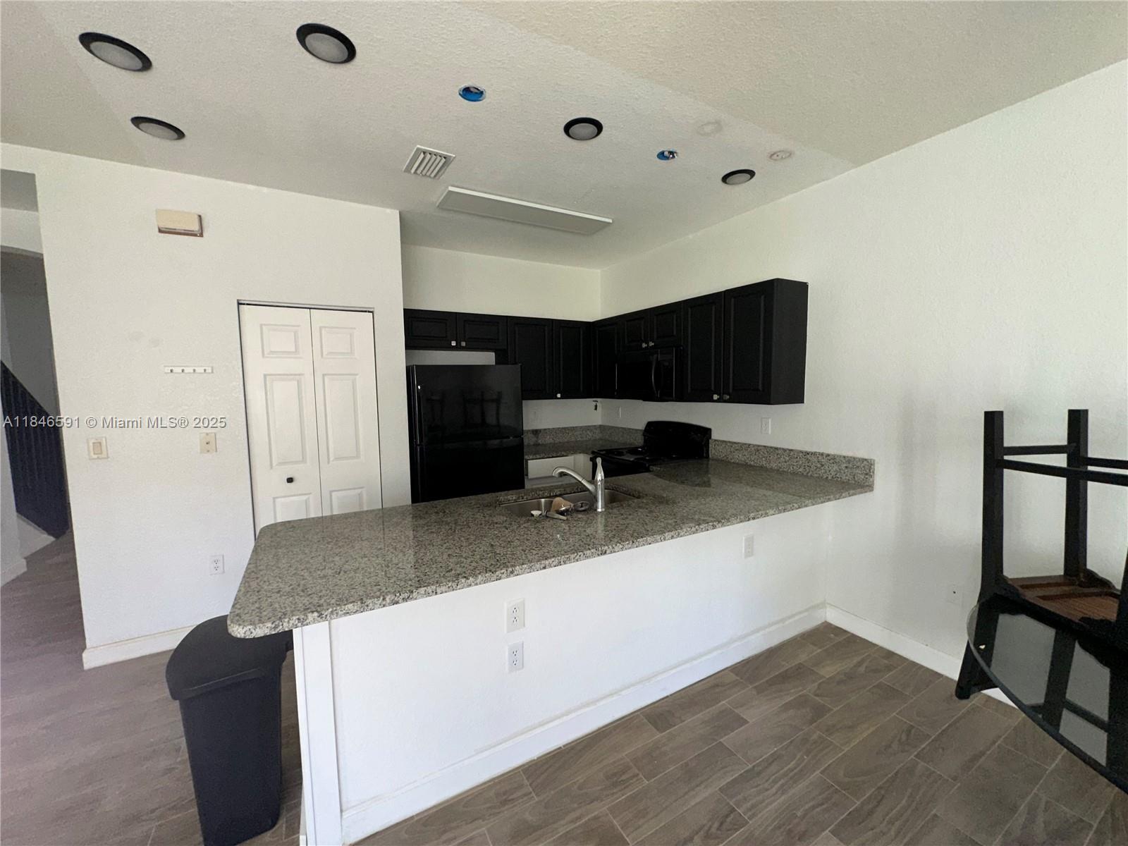 4908 Southwest 141st Avenue, Unit 3 Miramar, FL 33027 - Photo 6 of 29 a living room with stainless steel appliances kitchen island granite countertop furniture and a refrigerator