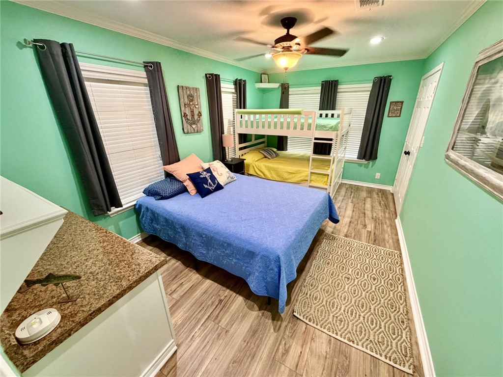 712 Tanglewood Somerville, TX 77879 - Photo 17 of 42 Bedroom with light wood finished floors, a ceiling fan, crown molding, and recessed lighting