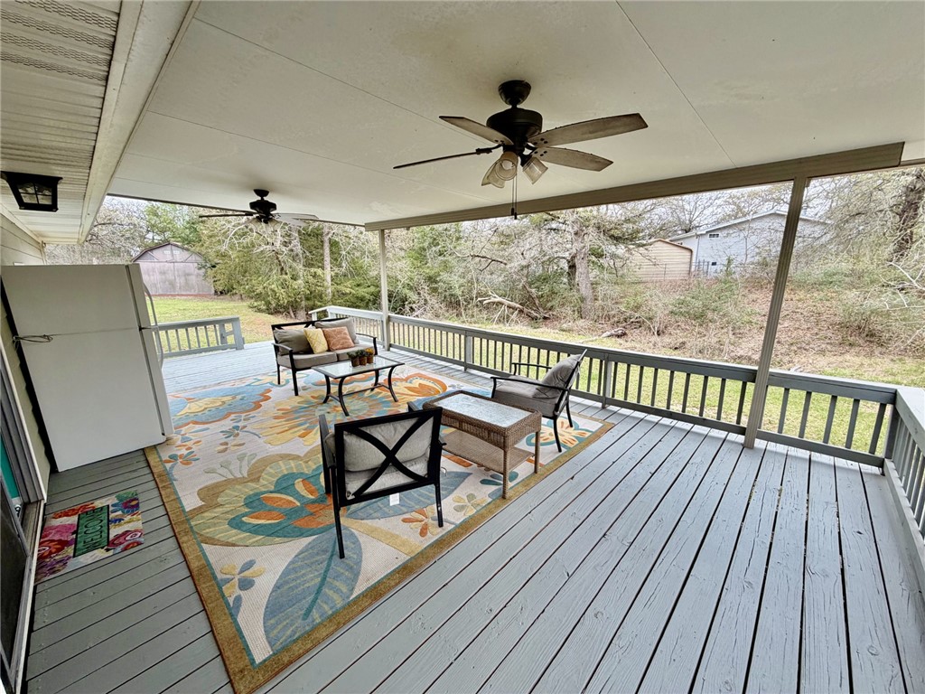 712 Tanglewood Somerville, TX 77879 - Photo 18 of 42 Wooden back deck with a ceiling fan and outdoor furniture
