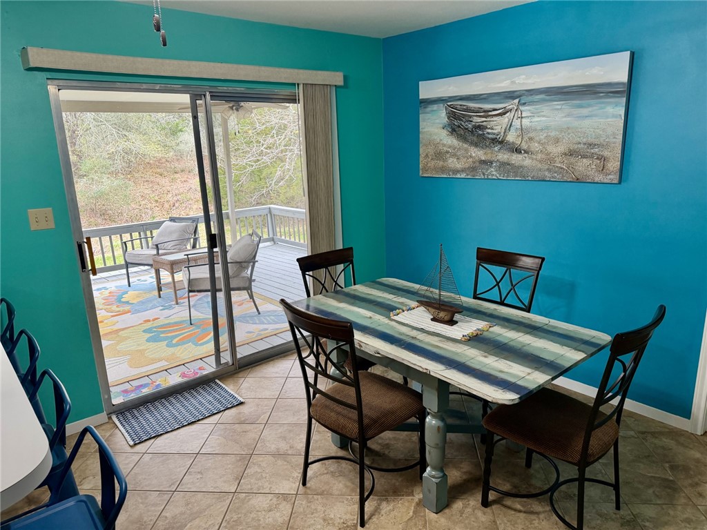 712 Tanglewood Somerville, TX 77879 - Photo 5 of 42 Tiled dining area that opens to the deck.