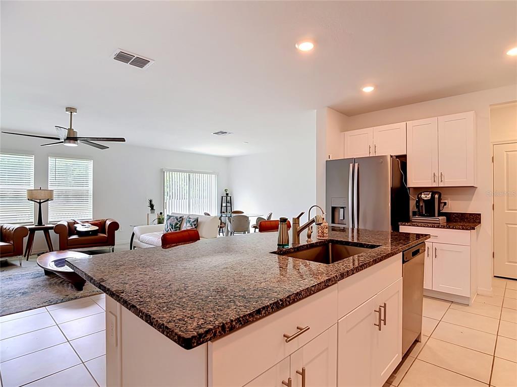 1633 Red Loop Lakeland, FL 33801 - Photo 3 of 60 a kitchen with granite countertop a sink and white cabinets