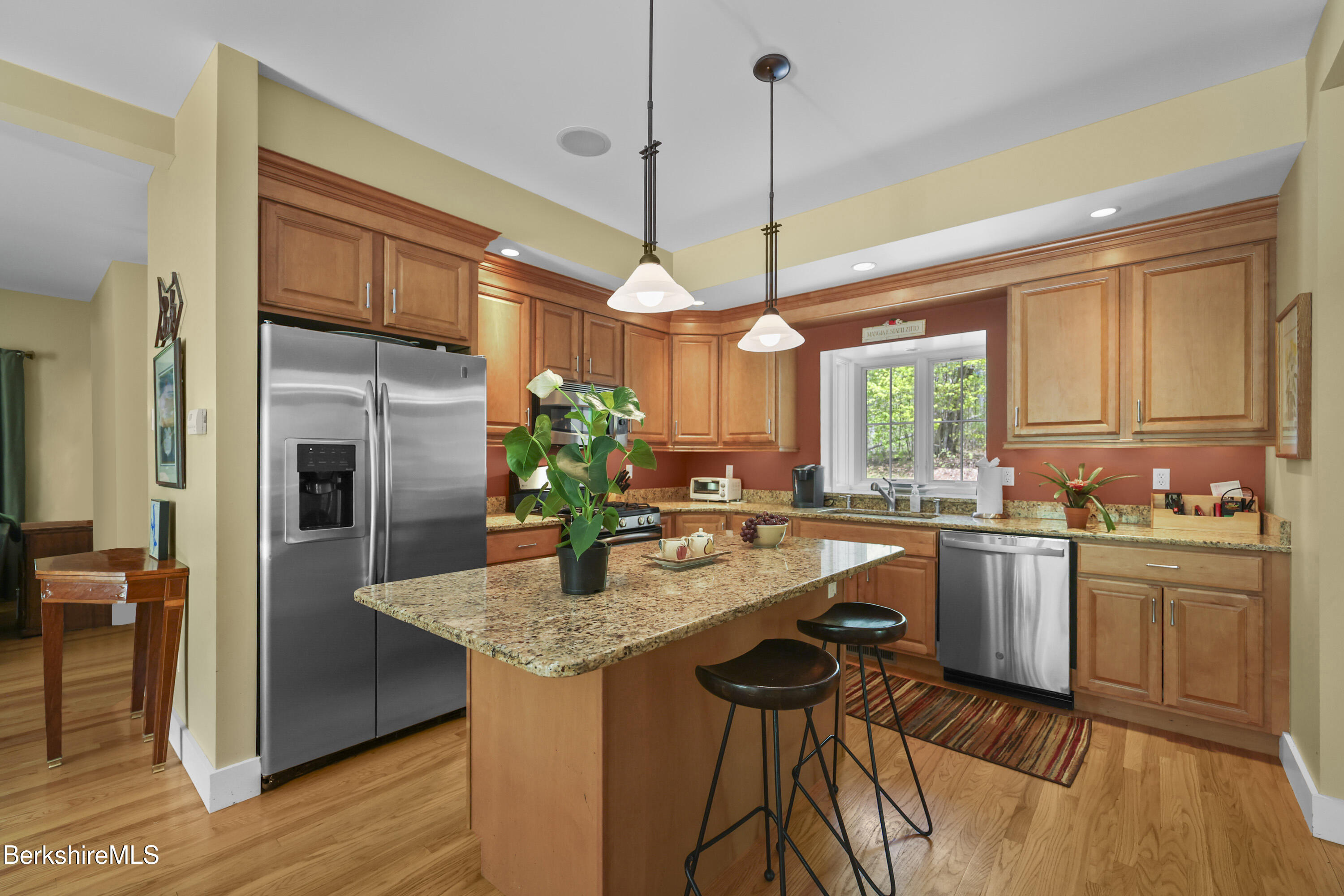 157 Pike Road Otis, MA 01029 - Photo 24 of 59 a kitchen with stainless steel appliances granite countertop wooden cabinets a window and a counter