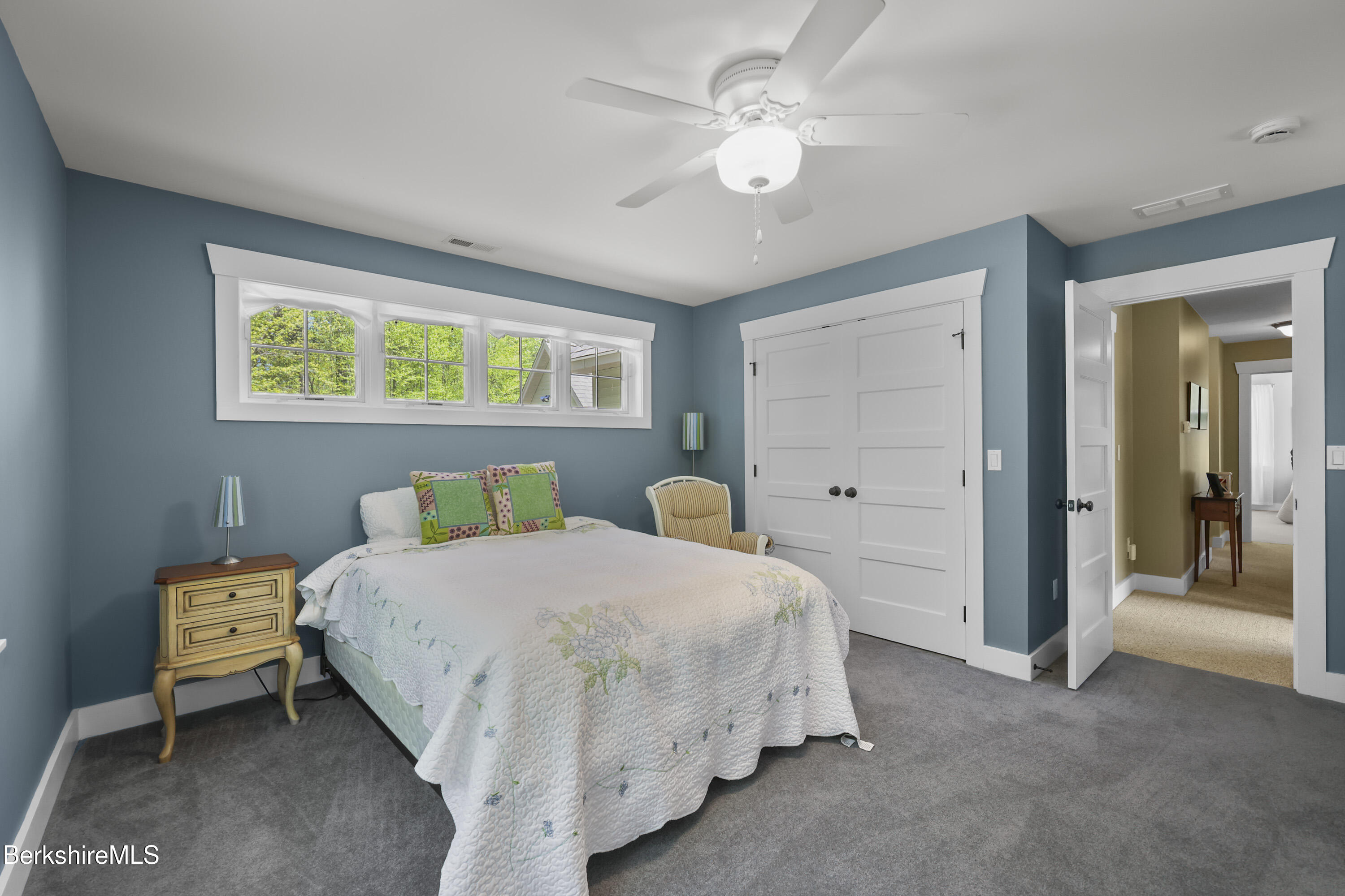 157 Pike Road Otis, MA 01029 - Photo 40 of 59 a bedroom with a bed and a chandelier