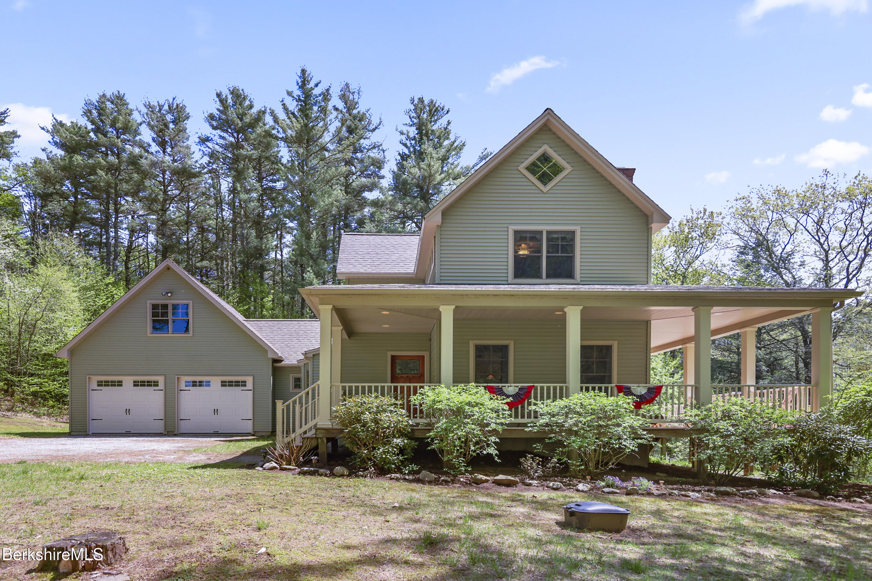 157 Pike Road Otis, MA 01029 - Photo 7 of 59 a front view of a house with a yard and garage