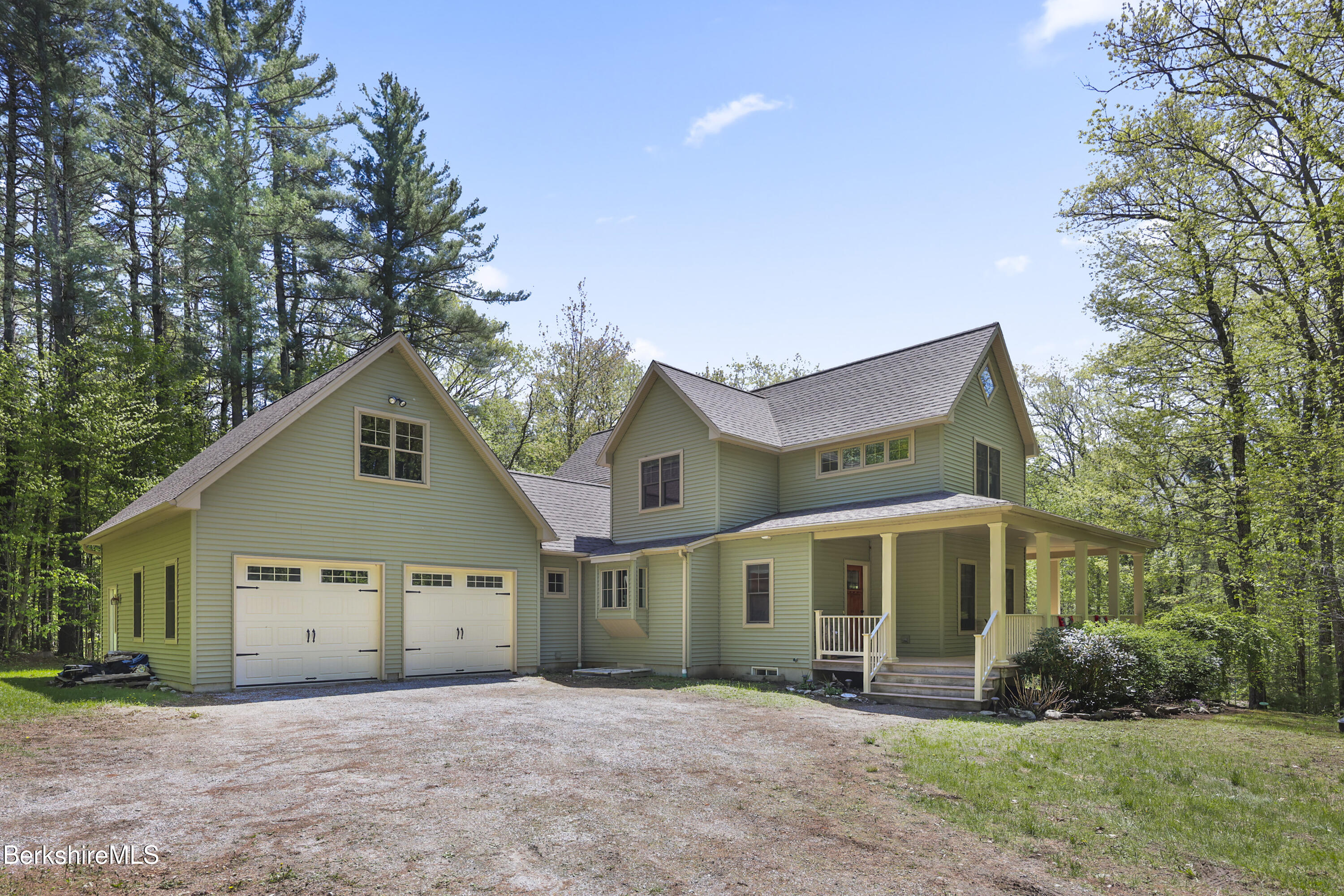 157 Pike Road Otis, MA 01029 - Photo 8 of 59 a front view of a house with a yard and garage