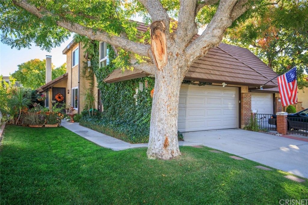 27020 Rio Pecos Drive Valencia, CA 91354 - Photo 1 of 1 a front view of a house with a garden and yard