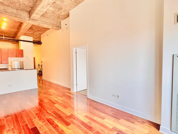 a view of a room with wooden floor
