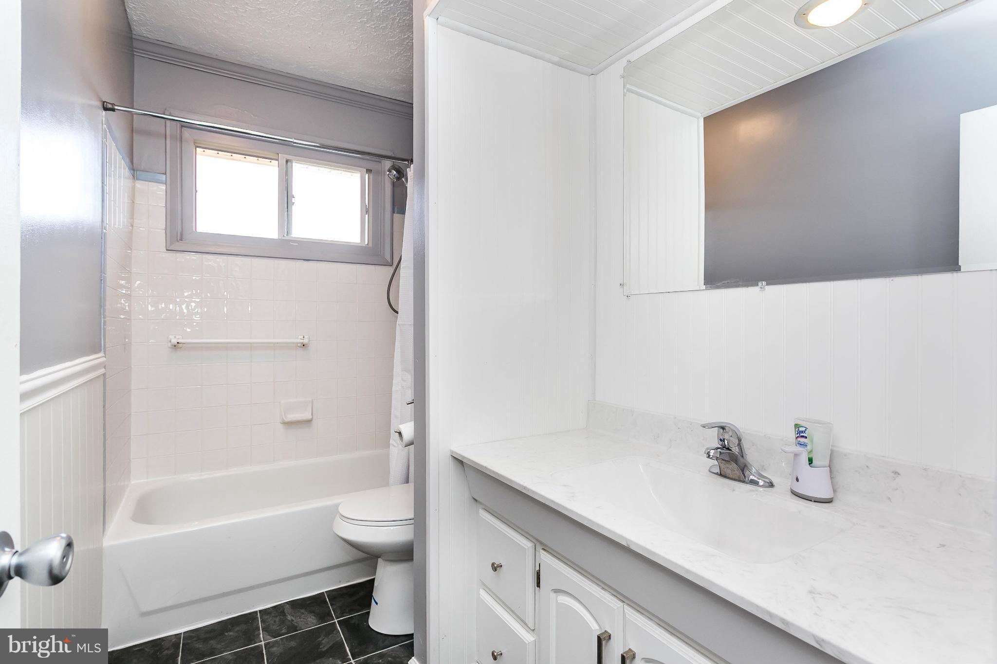 1217 Gettig Road Baltimore, MD 21237 - Photo 3 of 22 a bathroom with a sink a toilet and shower