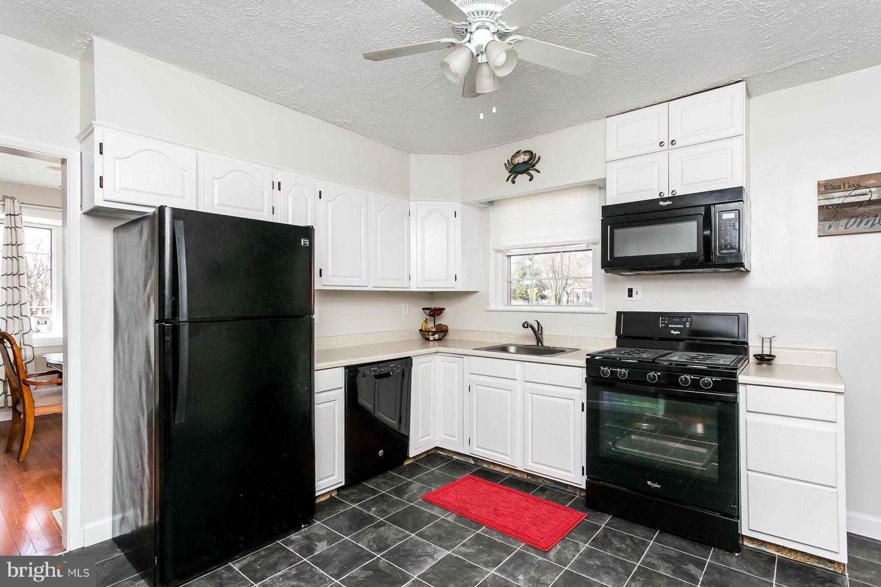 1217 Gettig Road Baltimore, MD 21237 - Photo 22 of 22 a kitchen with a refrigerator stove and microwave