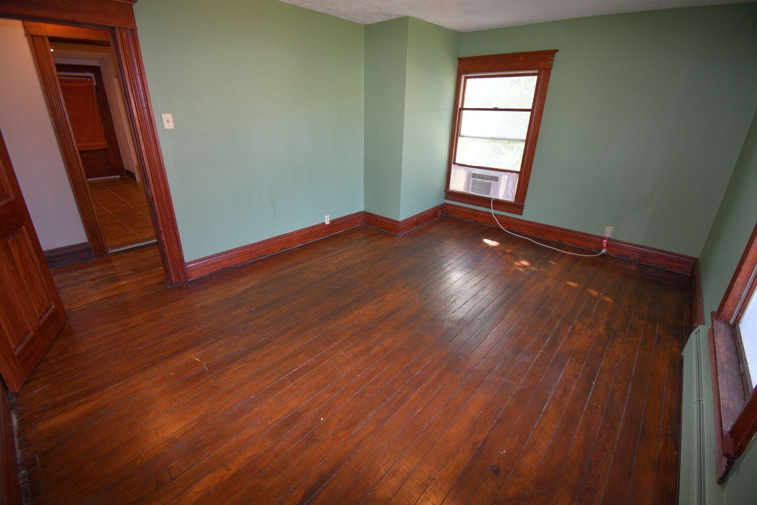 513 North College Avenue Rensselaer, IN 47978 - Photo 19 of 29 an empty room with wooden floor and windows