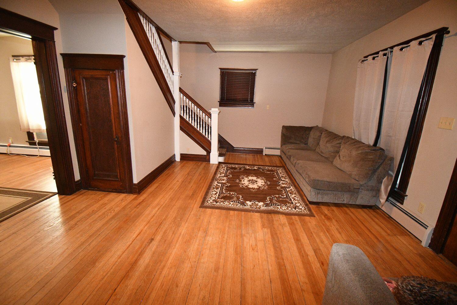 513 North College Avenue Rensselaer, IN 47978 - Photo 4 of 29 a living room with wooden floor and a rug