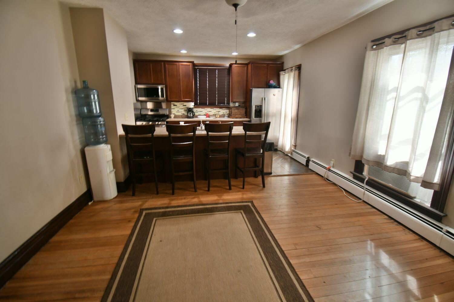 513 North College Avenue Rensselaer, IN 47978 - Photo 6 of 29 a kitchen with a table chairs refrigerator and window