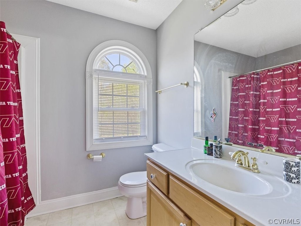 11736 Winterpock Road Chesterfield, VA 23838 - Photo 27 of 50 a bathroom with a granite countertop toilet a sink and a mirror