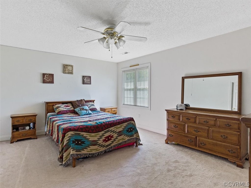11736 Winterpock Road Chesterfield, VA 23838 - Photo 31 of 50 a bedroom with a bed and a chandelier