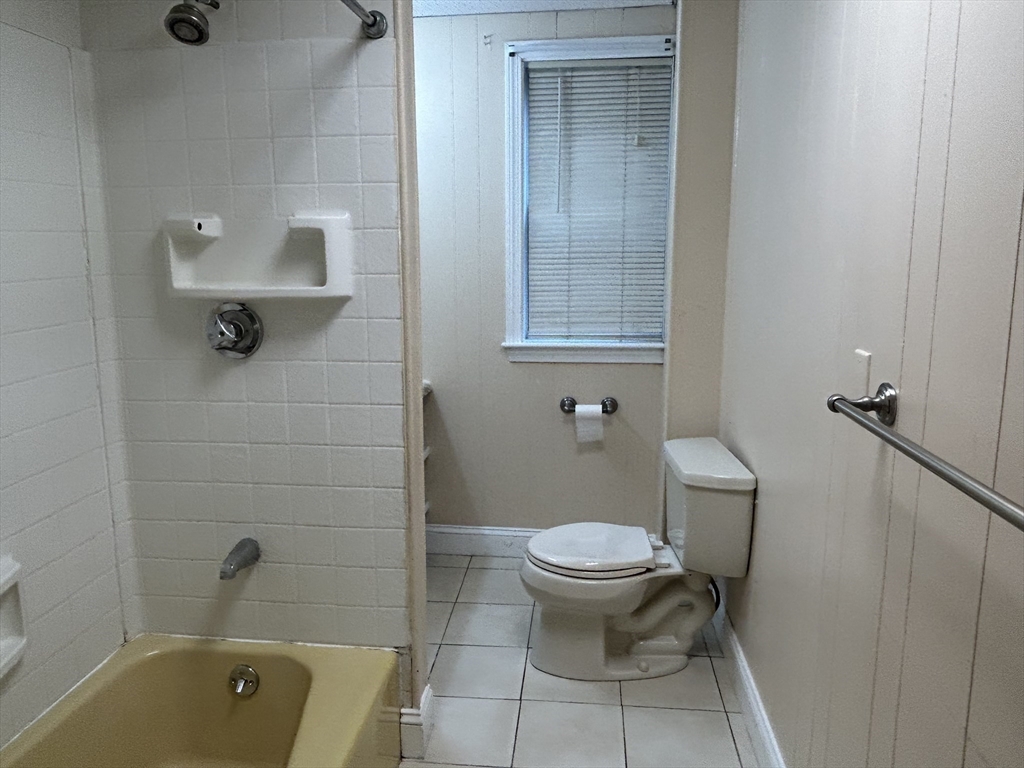 125 Spring Street, Unit 1 Medford, MA 02155 - Photo 10 of 12 a bathroom with a toilet and a tub