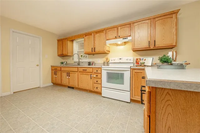 a view of kitchen with furniture and refrigerator
