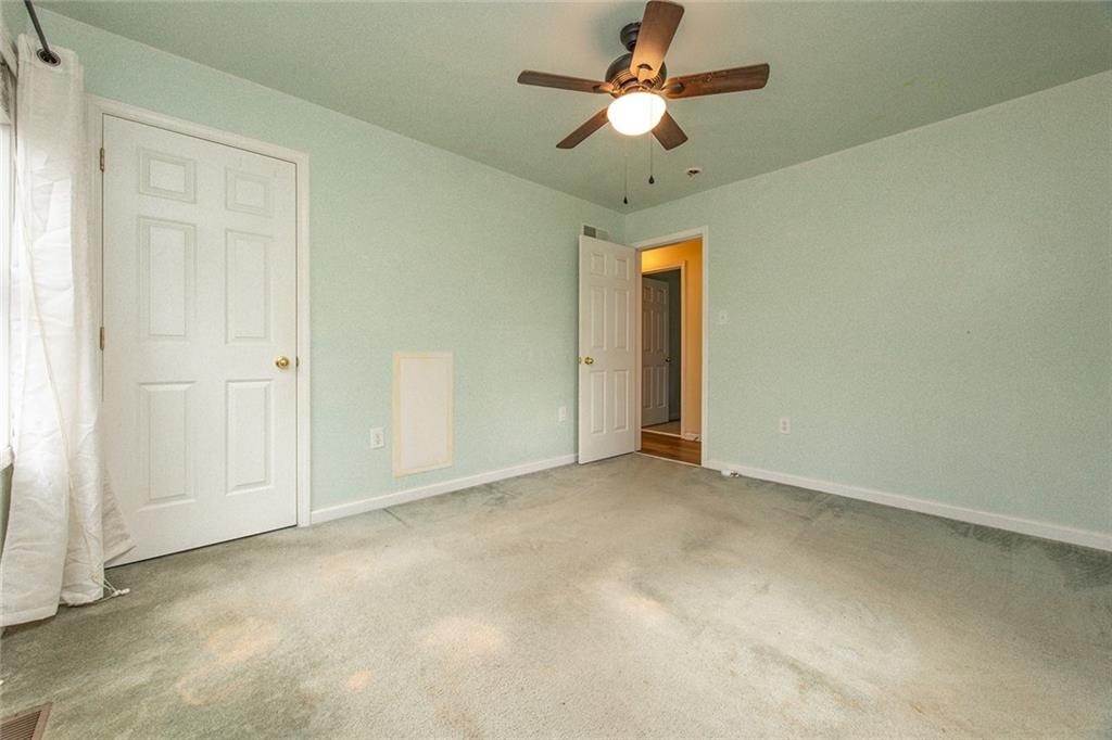 222 Hines Road Slippery Rock, PA 16057 - Photo 29 of 42 an empty room with a ceiling fan and a window